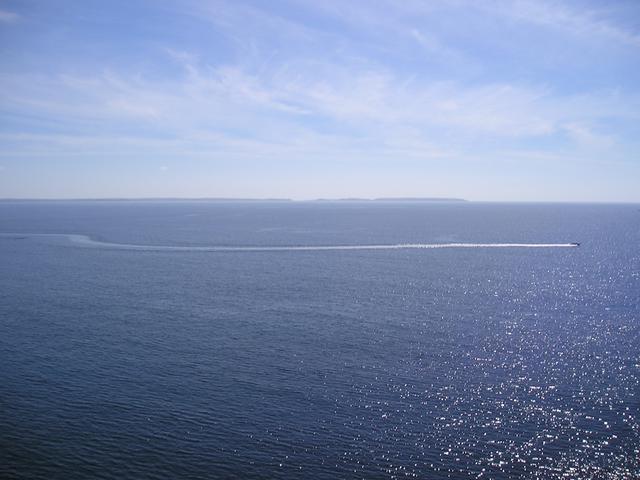 That's a boat full of people with lifejackets on. Admire the artistry of this picture, as if there was any in its taking.