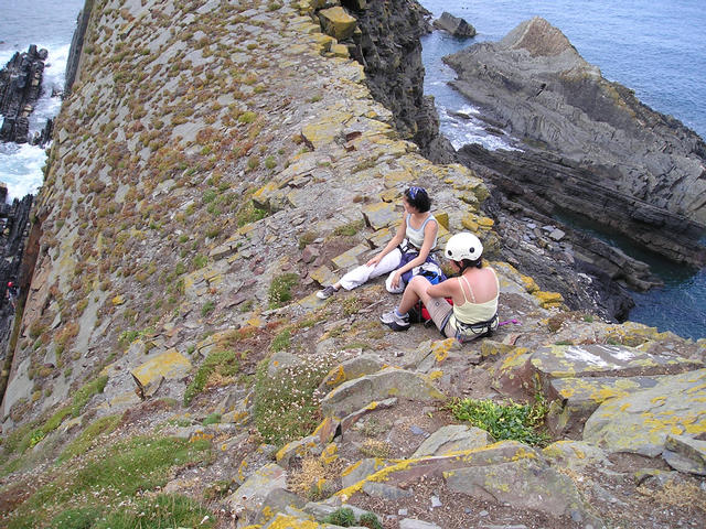 Manchi and Nening inspect the rather disturbing walk across to the abseil.